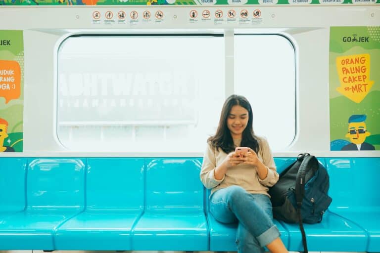 Girl using phone on the train