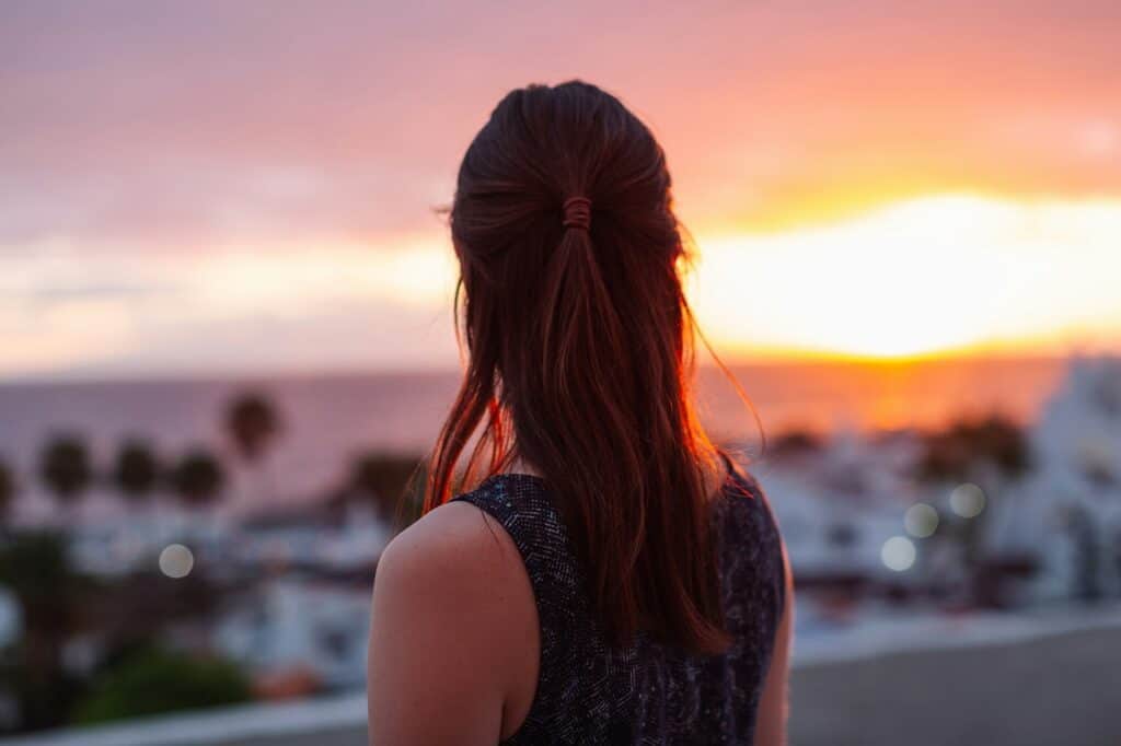 Girl looking out on sunset